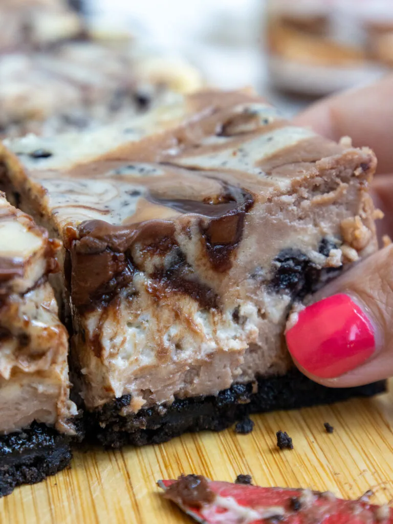 image of nutella cheesecake bar on a wood cutting board