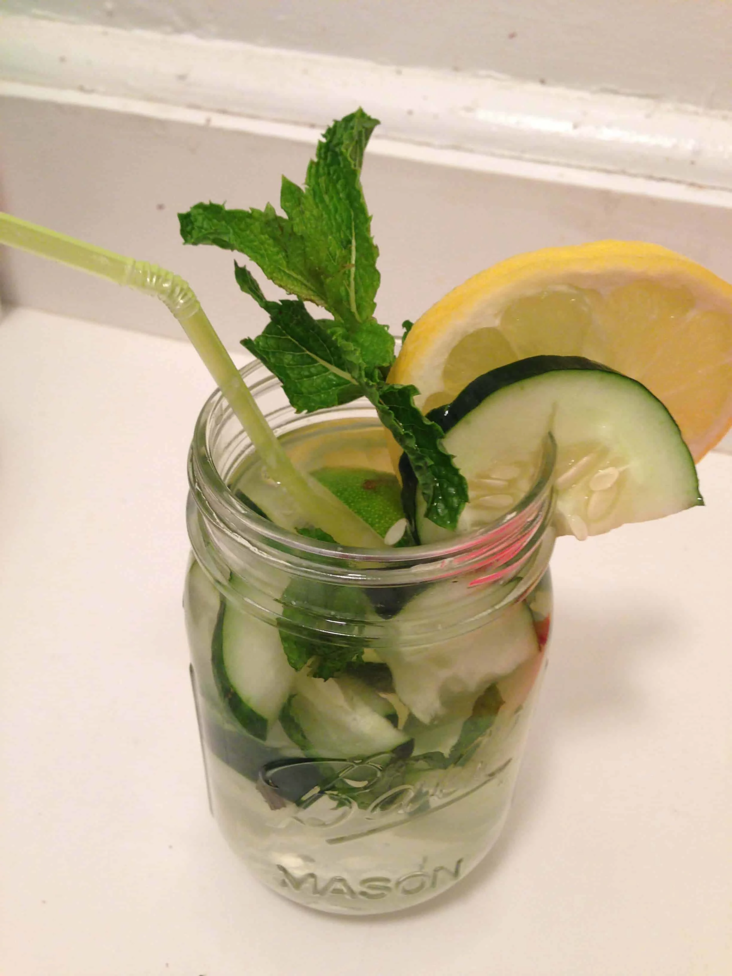 image of cucumber lemon water in a cute mason jar