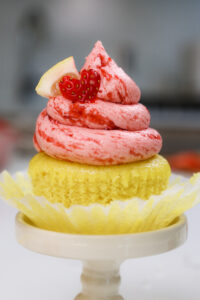 image of strawberry lemonade cupcakes decorated with a little lemon slice and cute heart shaped strawberry slice