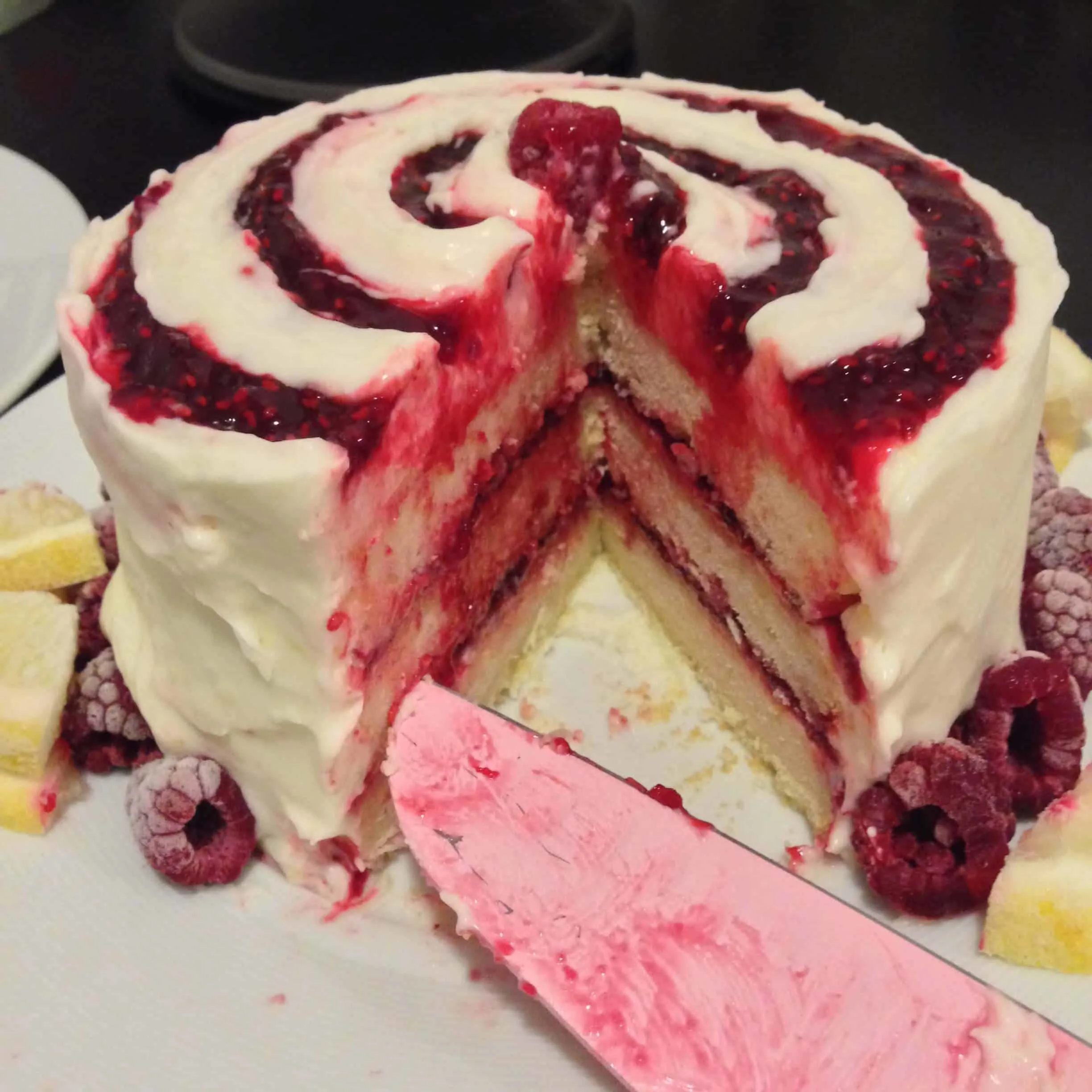 image of a lemon raspberry cake made with raspberry compote and cream cheese frosting