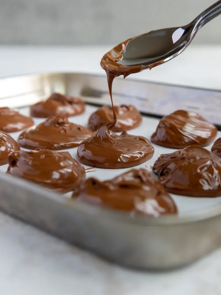 image of Nutella being spooned onto a sheet pan to be chilled