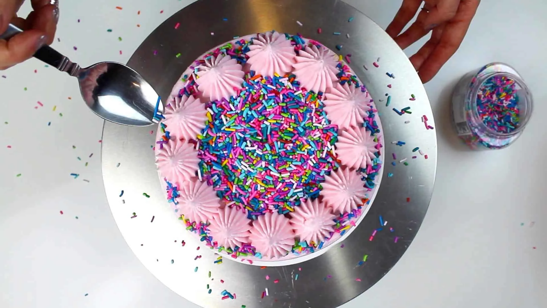 image of sprinkles on top of a vegan cake