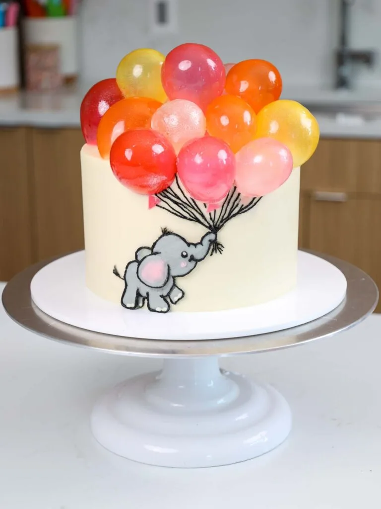 image of a baby shower cake decorated with gelatin balloons made from gelatin bubbles