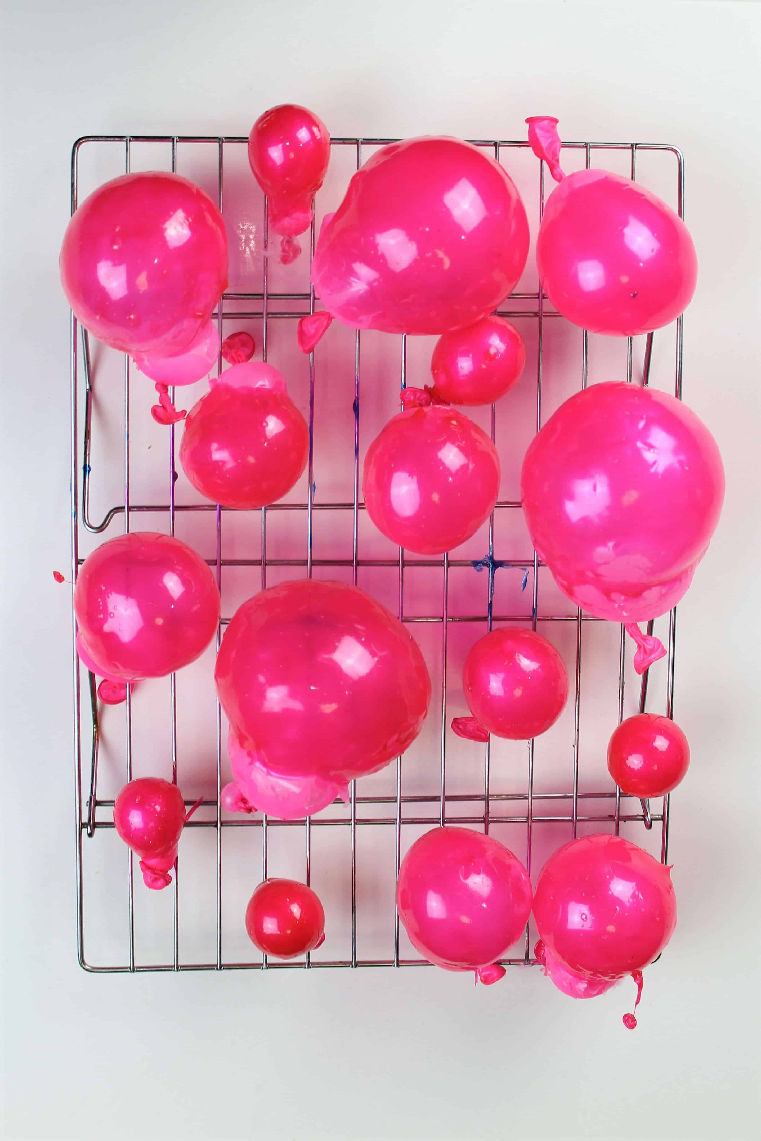 image of pink edible bubbles that have been made using gelatin and small balloons