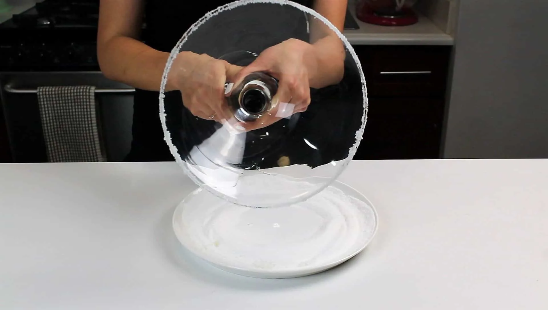 image of a giant cocktail glass being given a sugar rim to make a margarita trifle