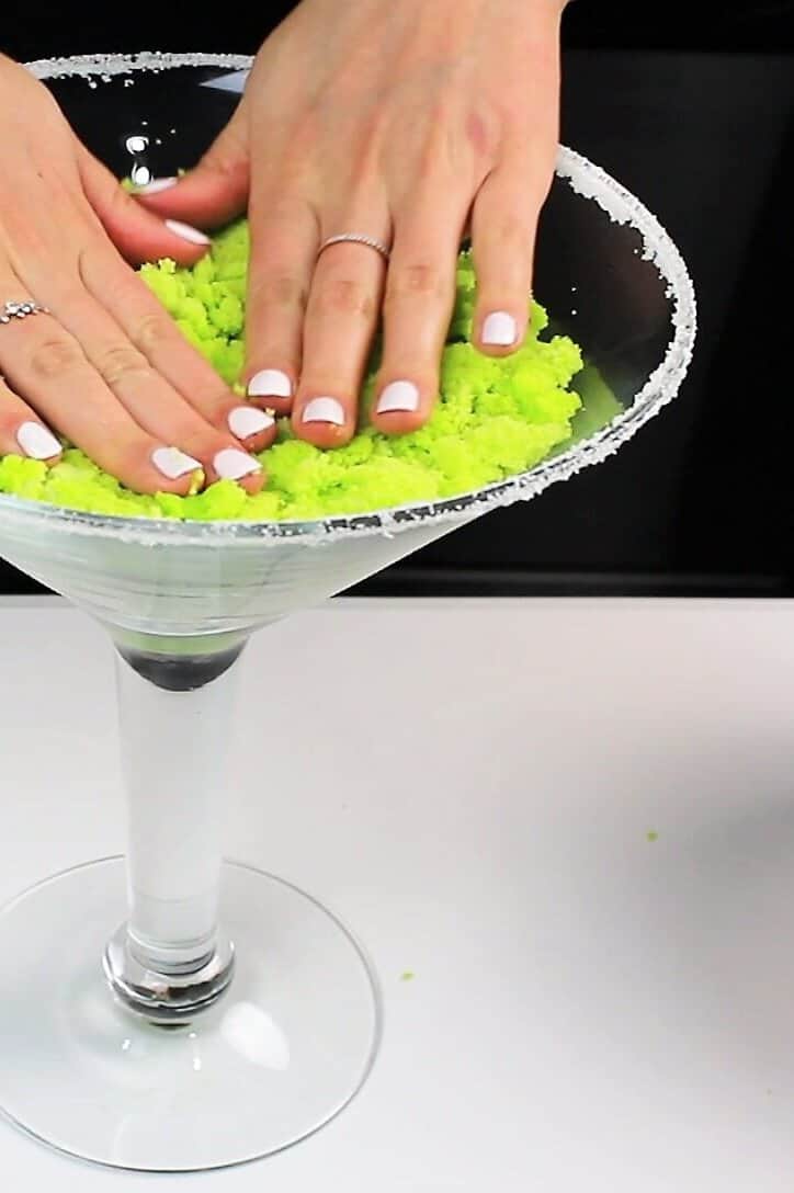 image of a  margarita trifle being built in an extra large cocktail glass with a sugared rim