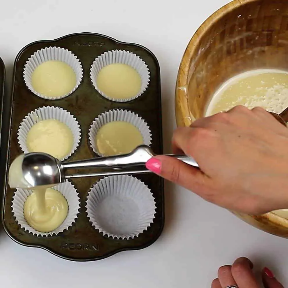 Scooping my vanilla cupcake batter into my cupcake liners