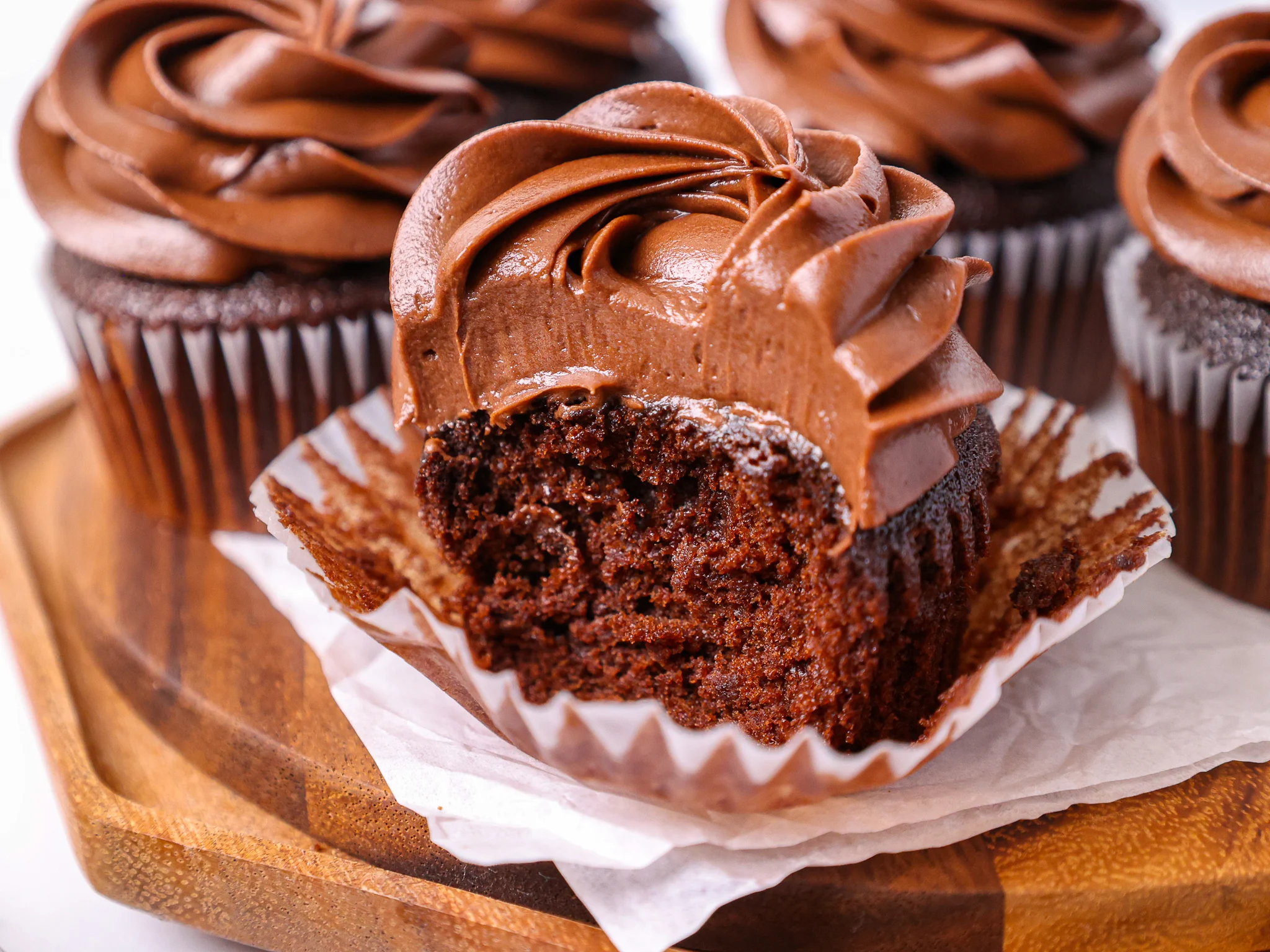 image of a moist chocolate cupcake that's been cut into to show how tender the crumb is