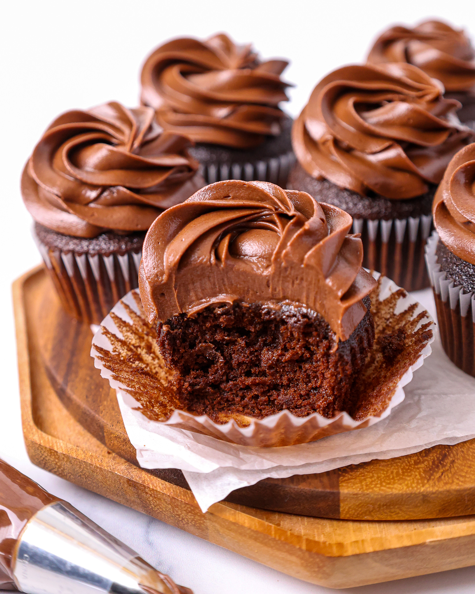 image of a moist chocolate cupcake that's been cut into to show how tender the crumb is