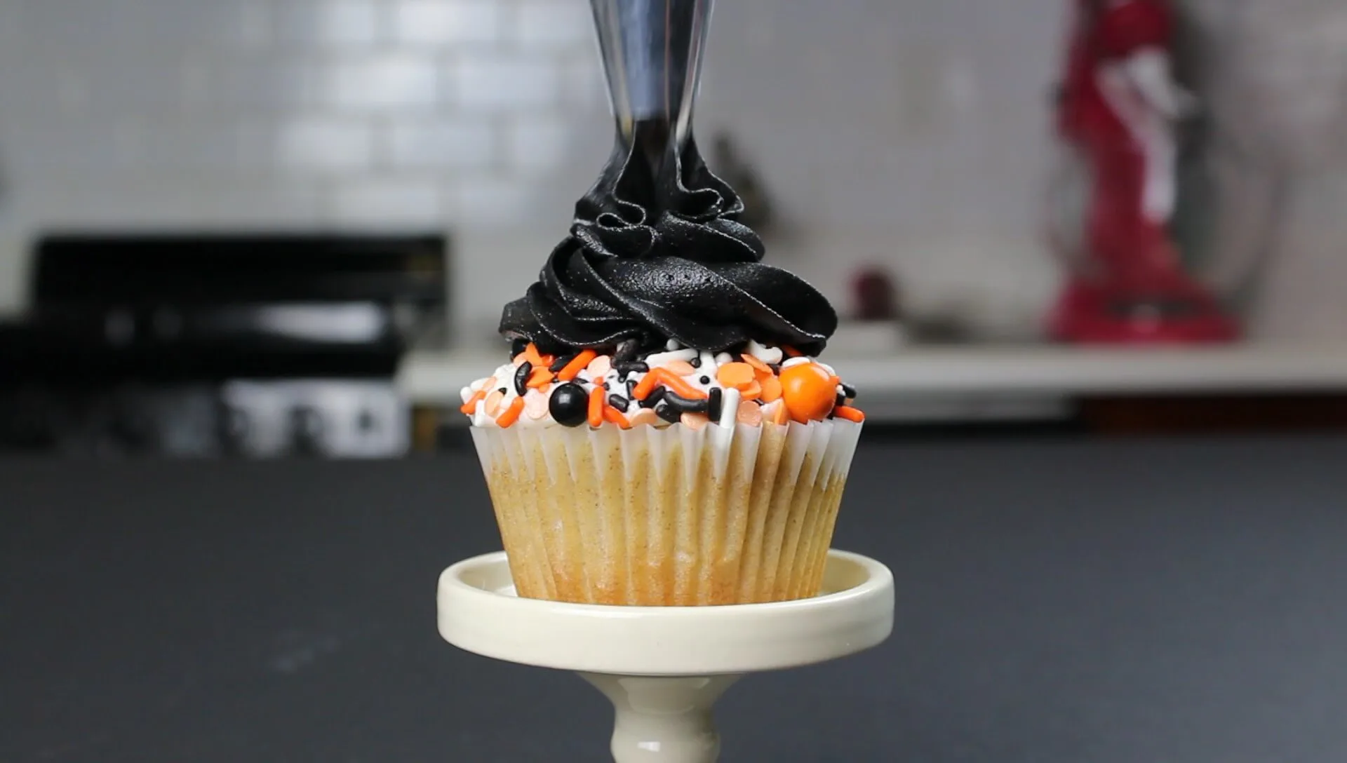 photo of simple sprinkle cupcake decorated with black buttercream for halloween