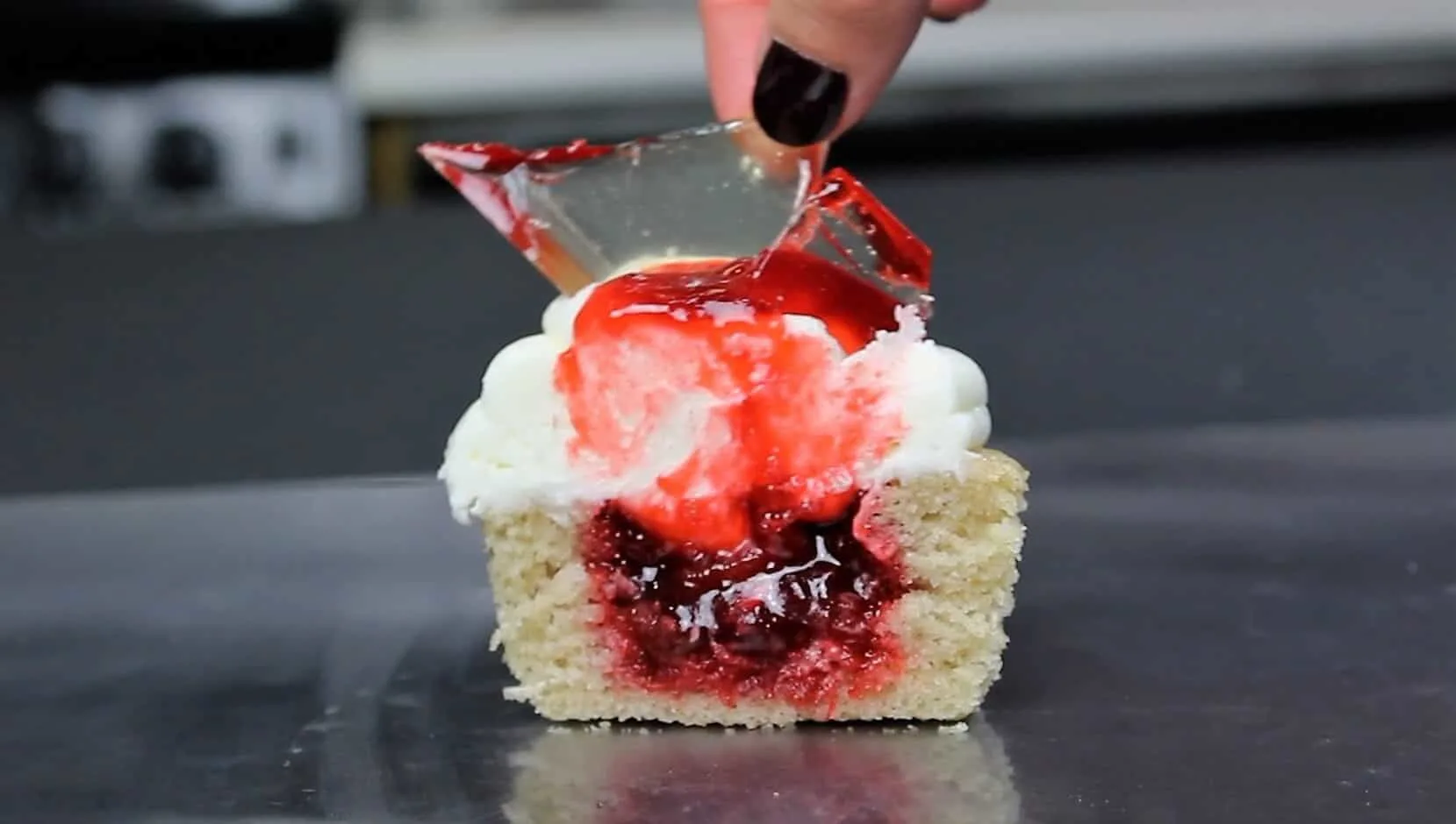 photo of cut open shattered glass cupcake, filled with strawberry jam