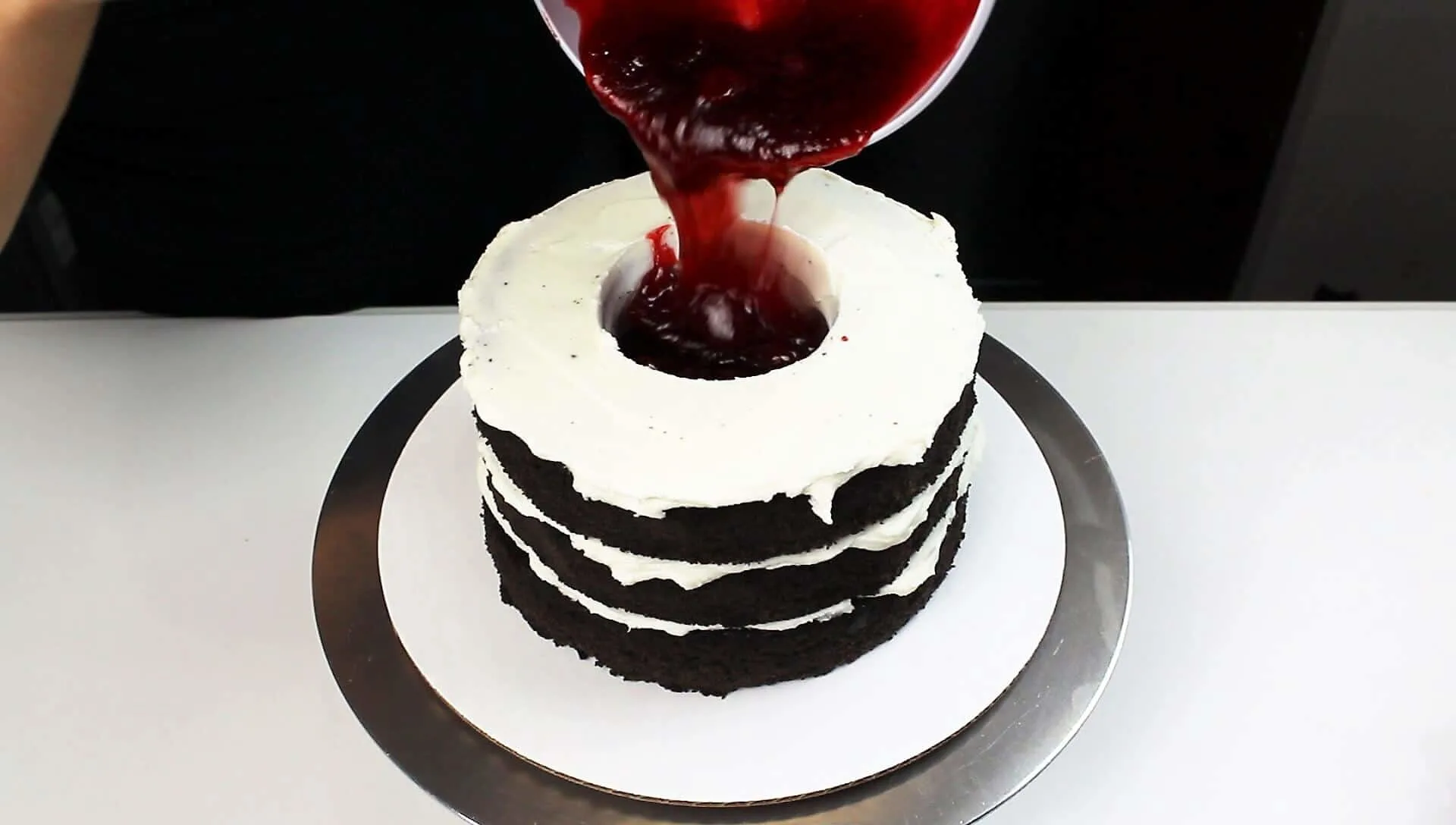 photo of adding strawberry jam into my vampire bat cake