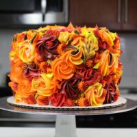 image of an apple pie layer cake that's been decorated with pretty Fall buttercream