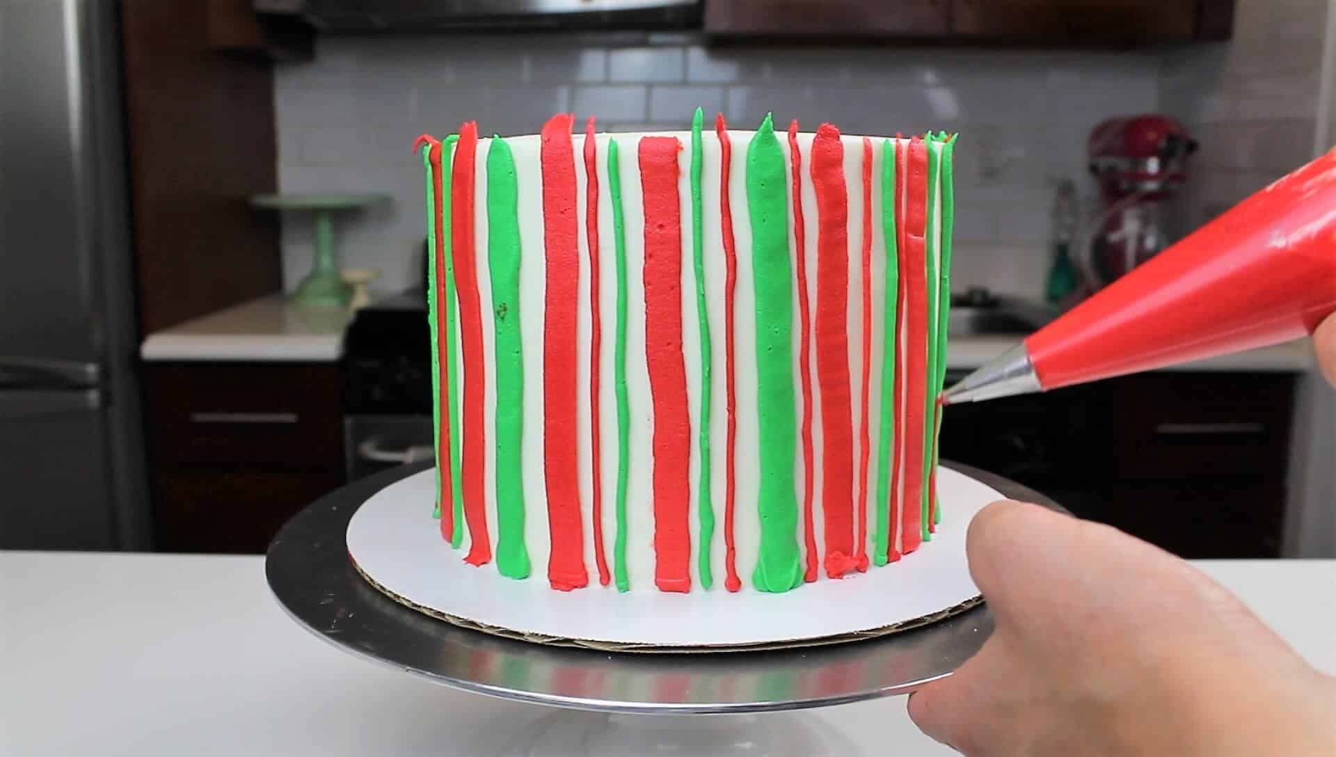 Image of adding stripes to a christmas cake
