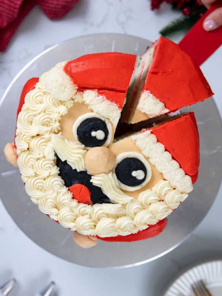 image of a Santa cake that's been cut into with a red knife