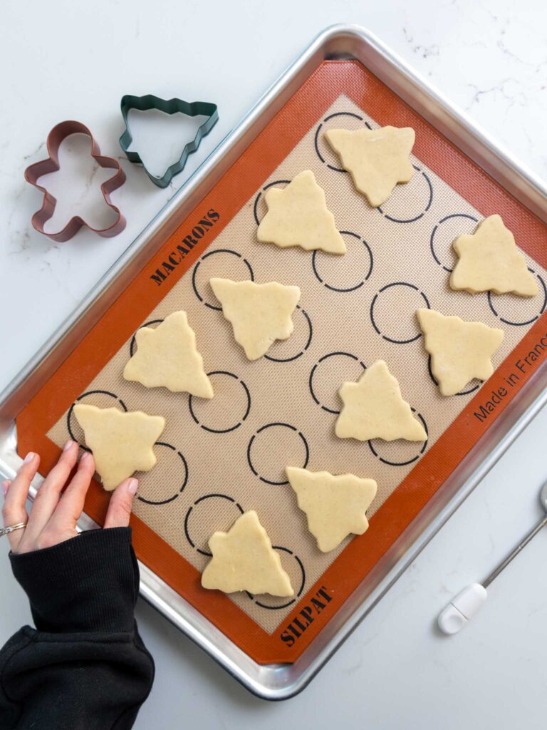 image of cream cheese cookies that have been cut out and placed on a silicone mat