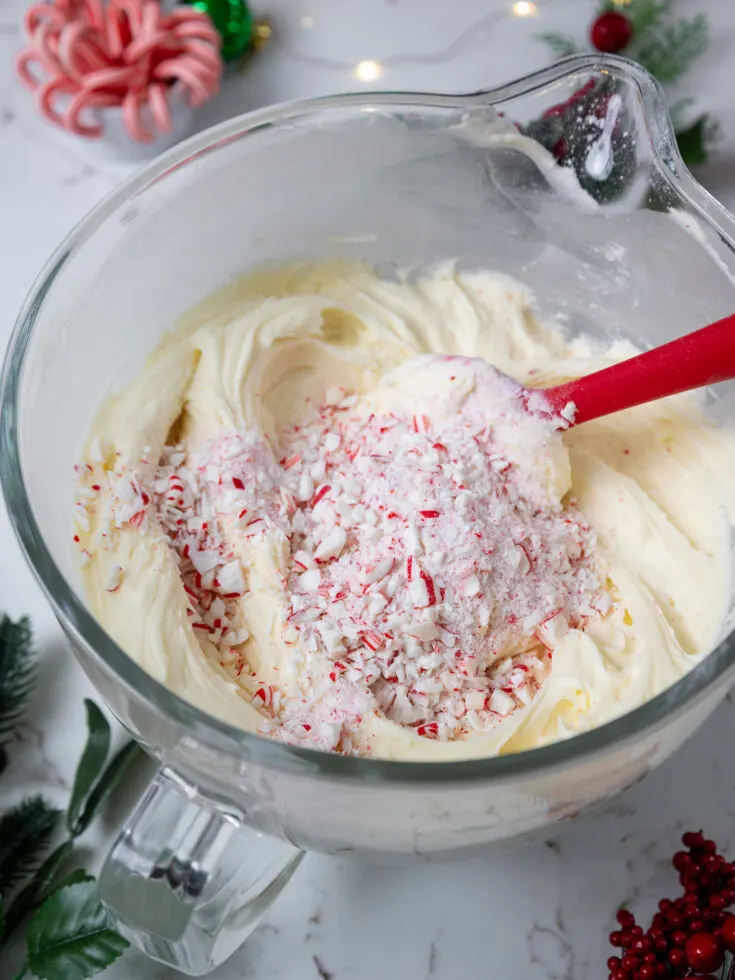 image of peppermint candy cane buttercream being made in a large glass bowl