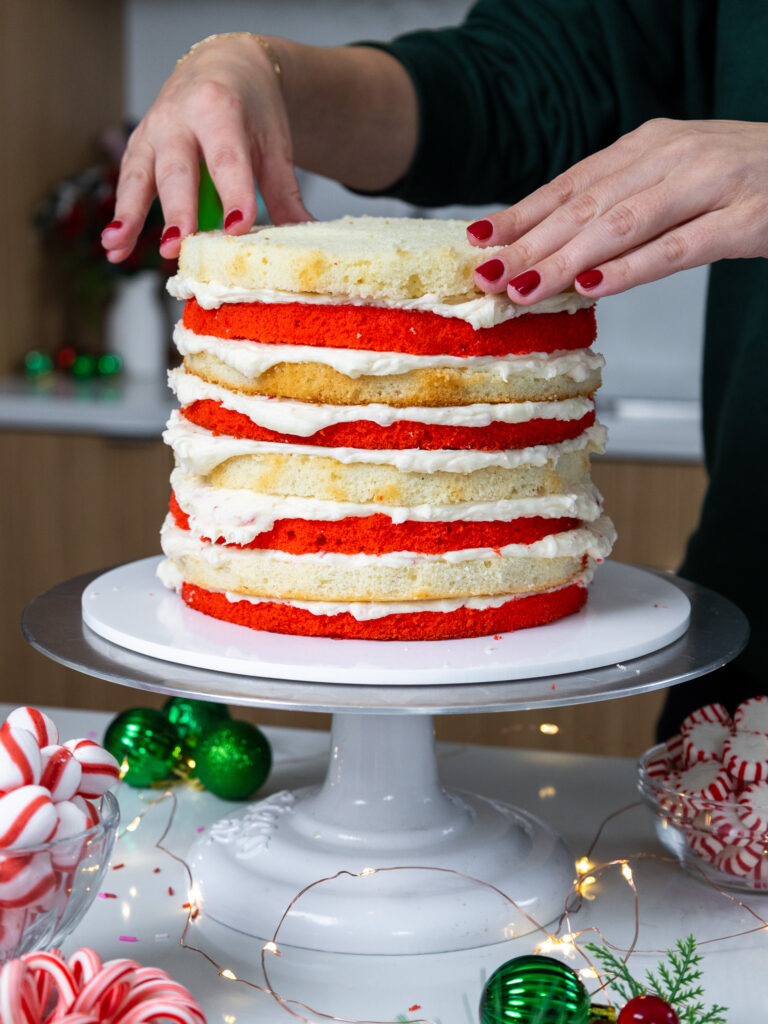 image of peppermint cake layers being stacked to make a candy cane cake