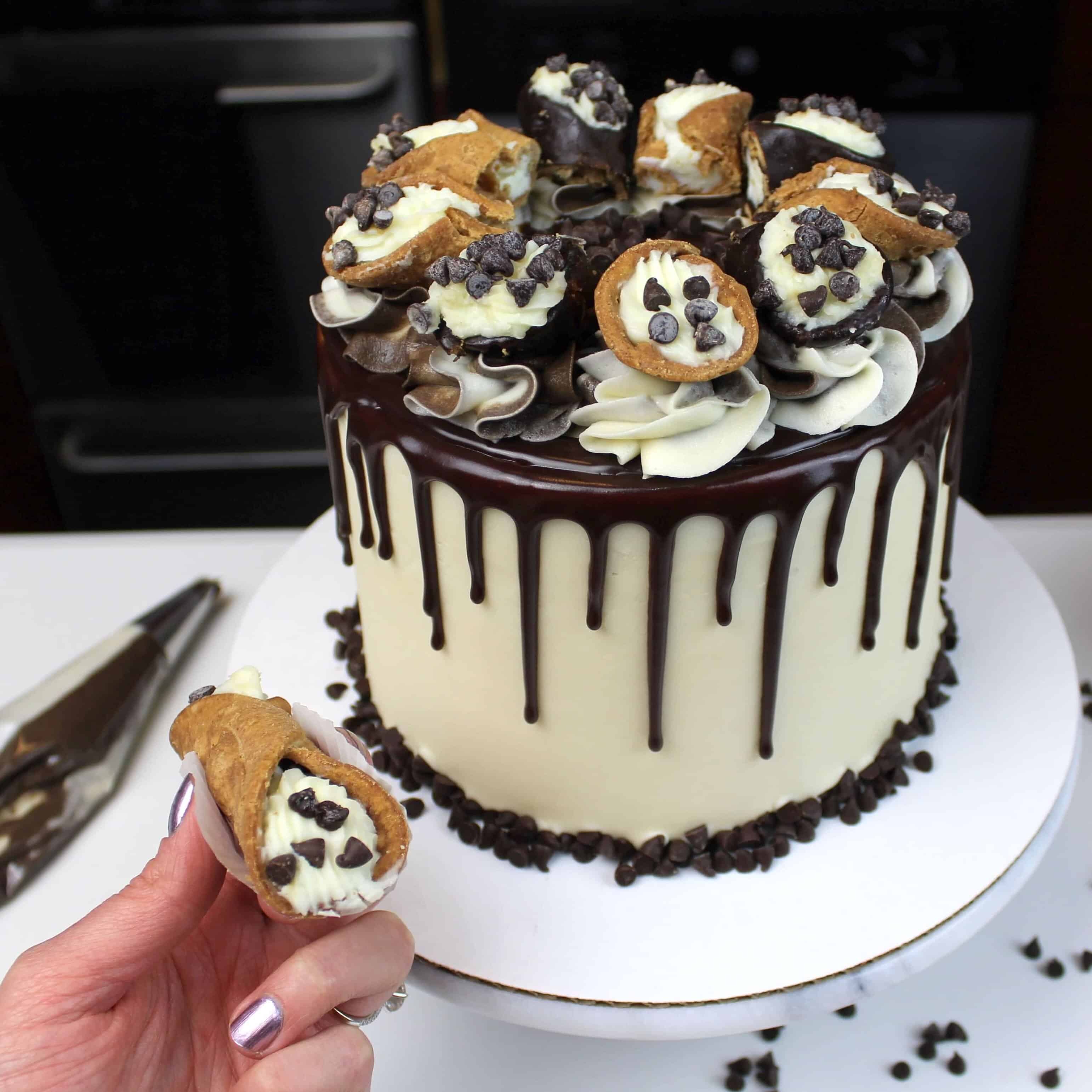image of cannoli cake with a chocolate drip
