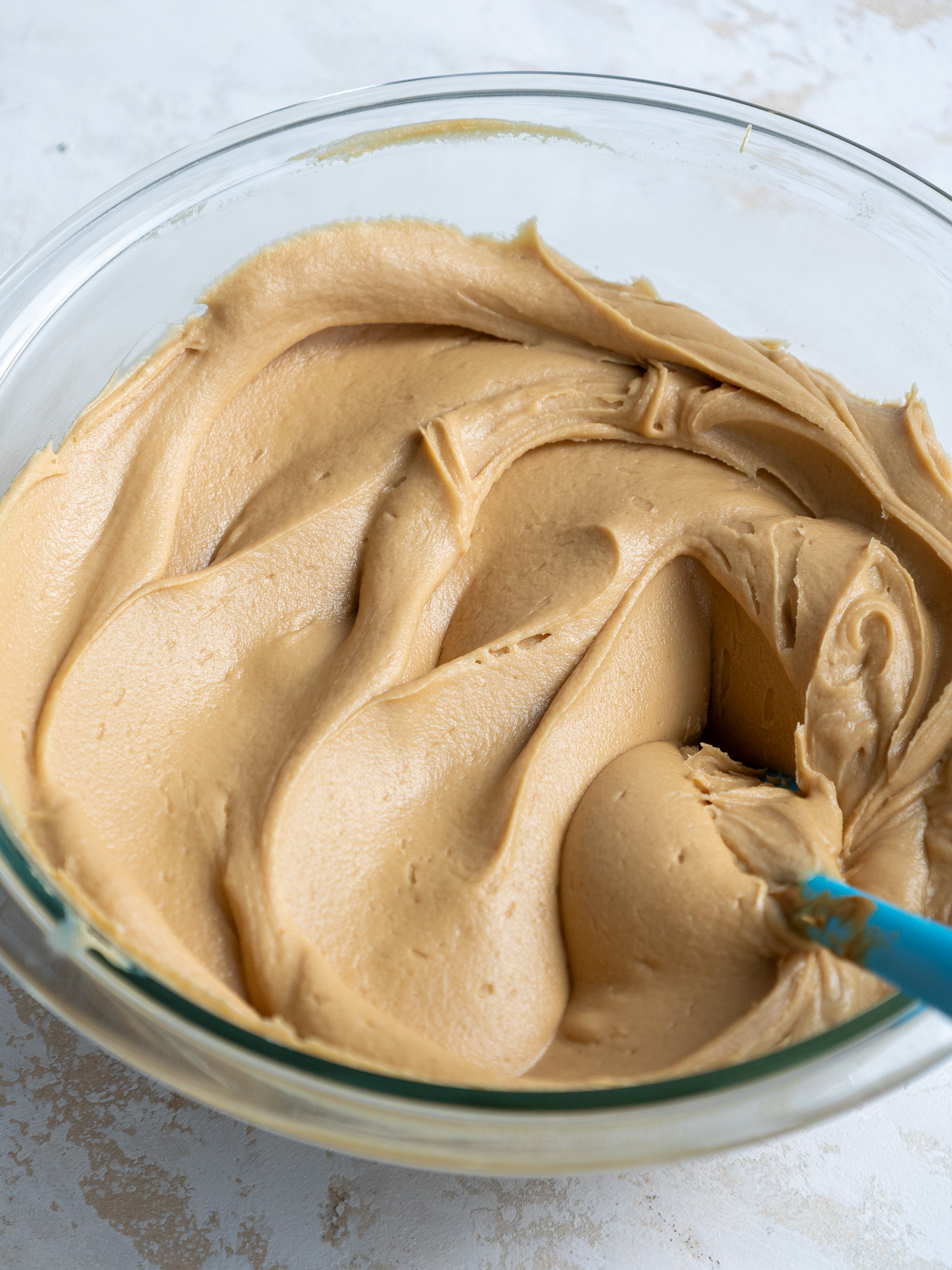 image of biscoff buttercream that's been mixed in a glass bowl