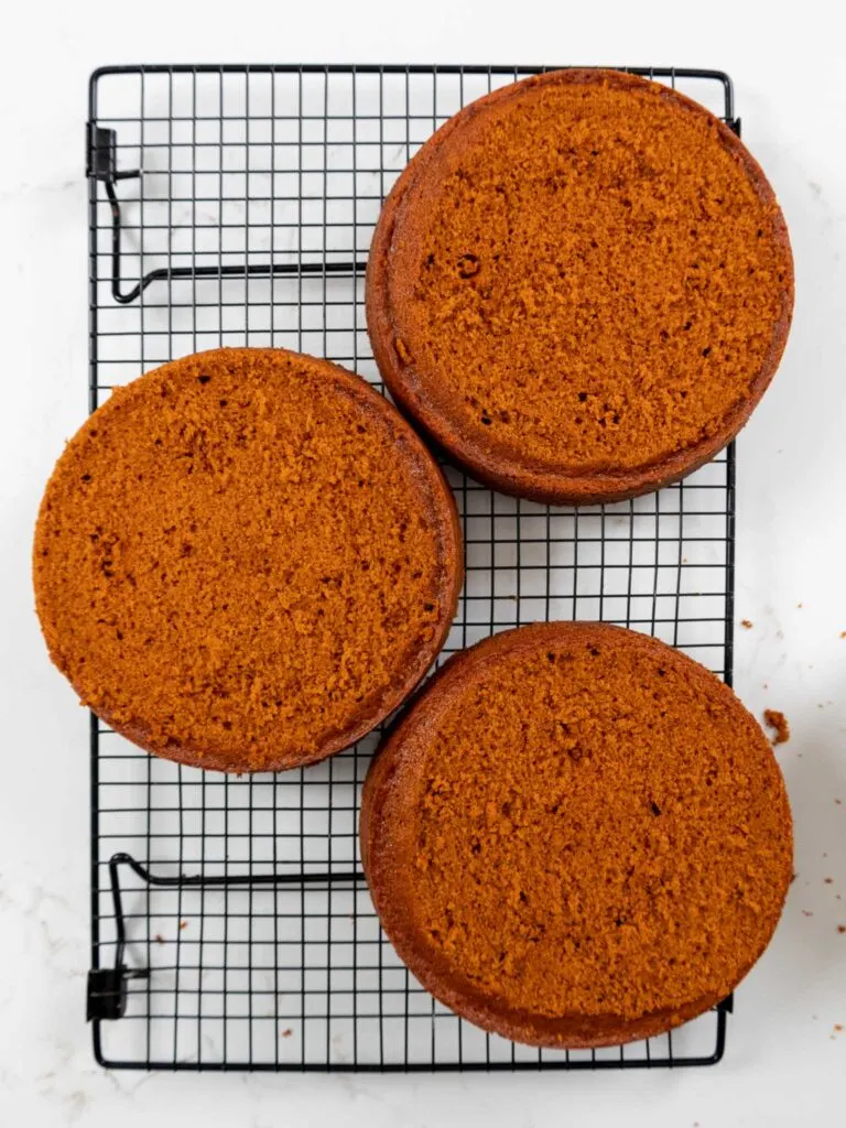 image of orange velvet cake layers that have been leveled with a serrated knife