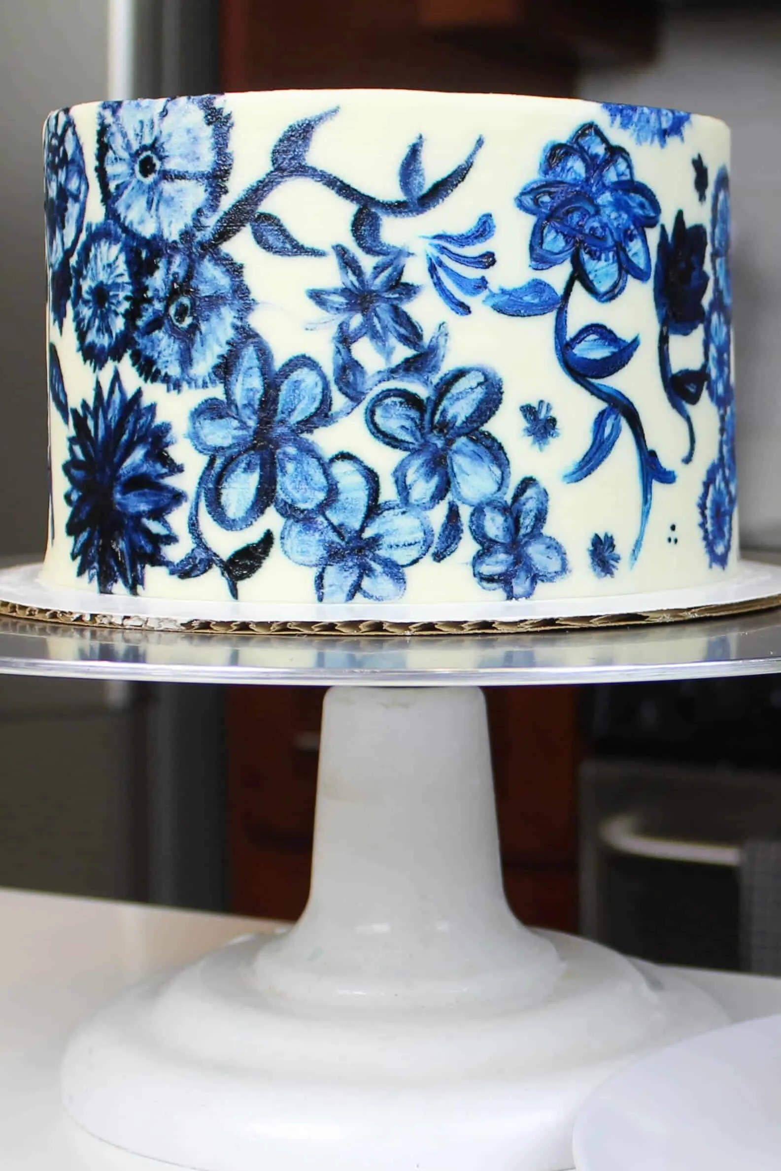 beautifully painted blue floral cake, made with 6 inch vanilla cake layers