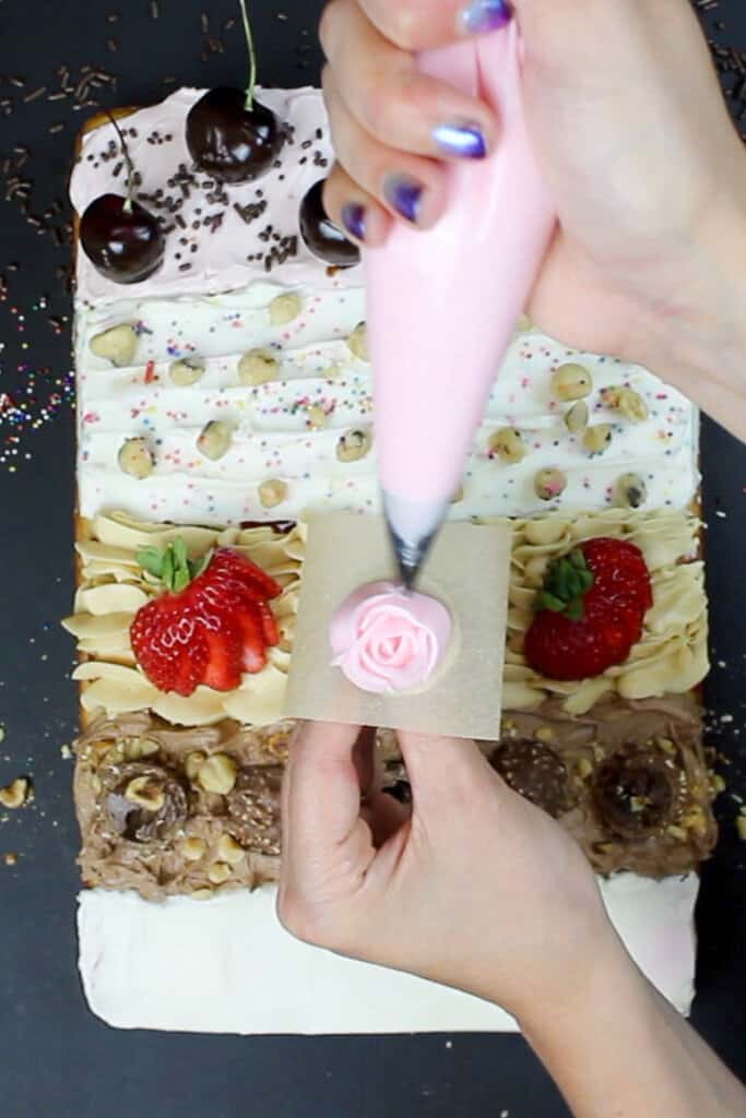 piping roses onto the rose water section of my sheet cake