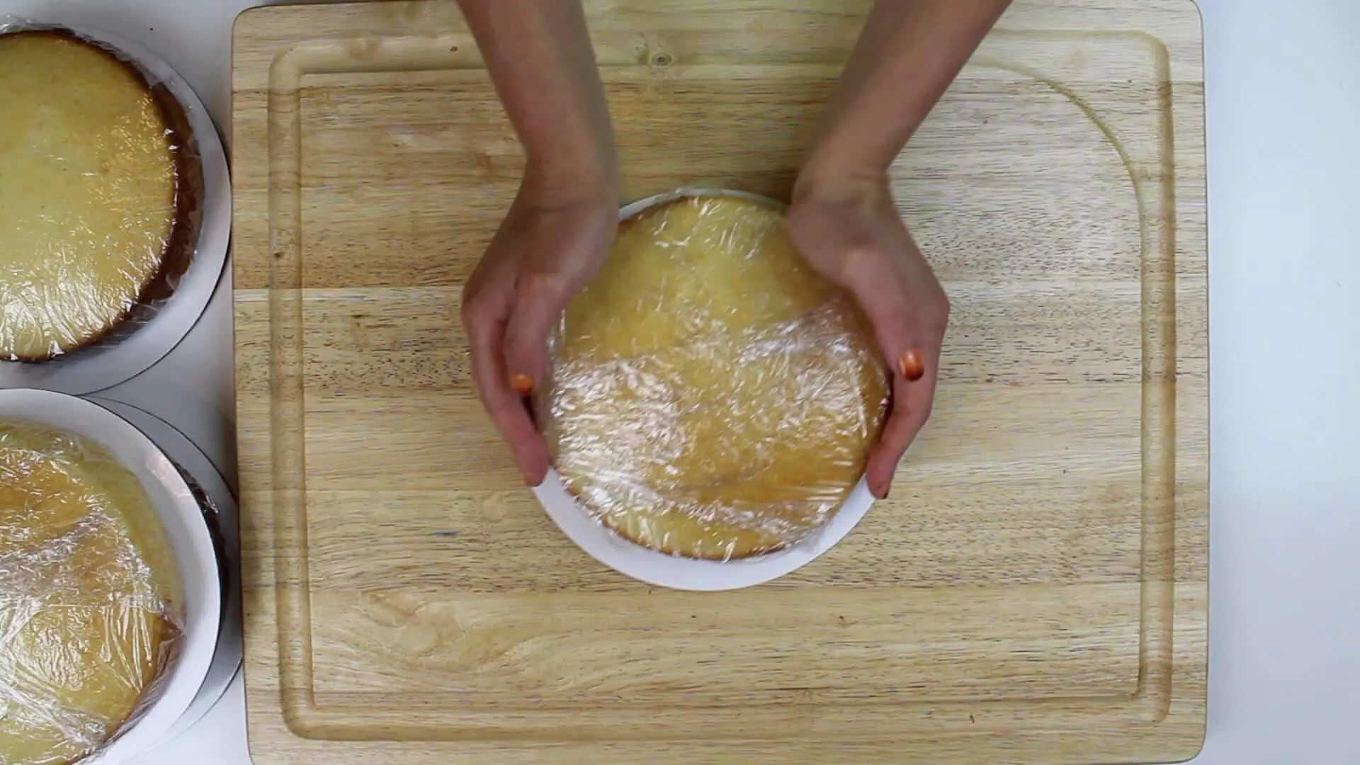 wrapped cake layer on cardboard round