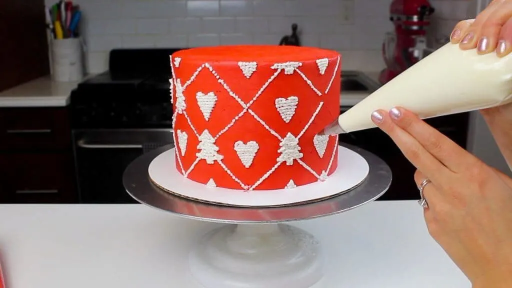 image of knitted sweater cake being piped with buttercream