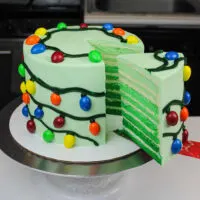 image of a christmas lights cake decorated with almond m & ms to look just like christmas lights