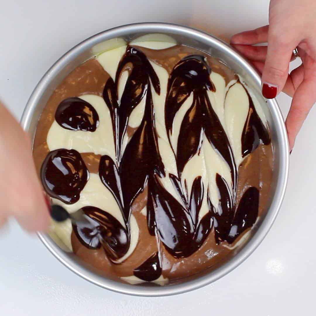 Swirling together the vanilla and chocolate cake batter to create my marble cake layers