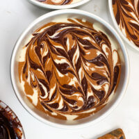 image of chocolate and vanilla marble cake layers that have been swirled with a fudge ripple and are ready to be baked