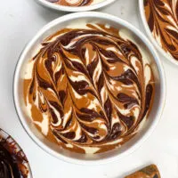 image of chocolate and vanilla marble cake layers that have been swirled with a fudge ripple and are ready to be baked