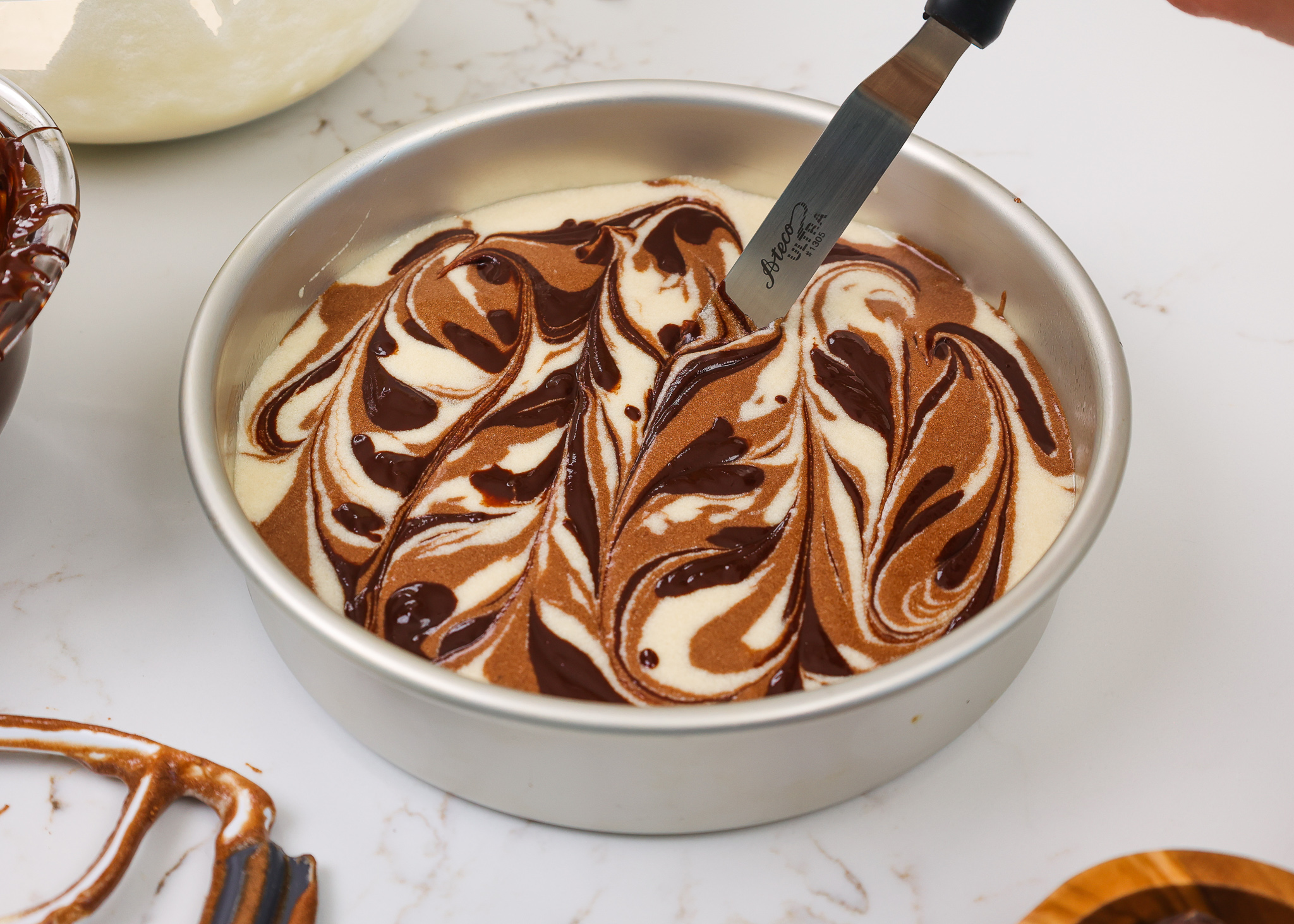Marbling Chocolate And Vanilla Cake Batter Together To Make Layered Marble Cakev1 