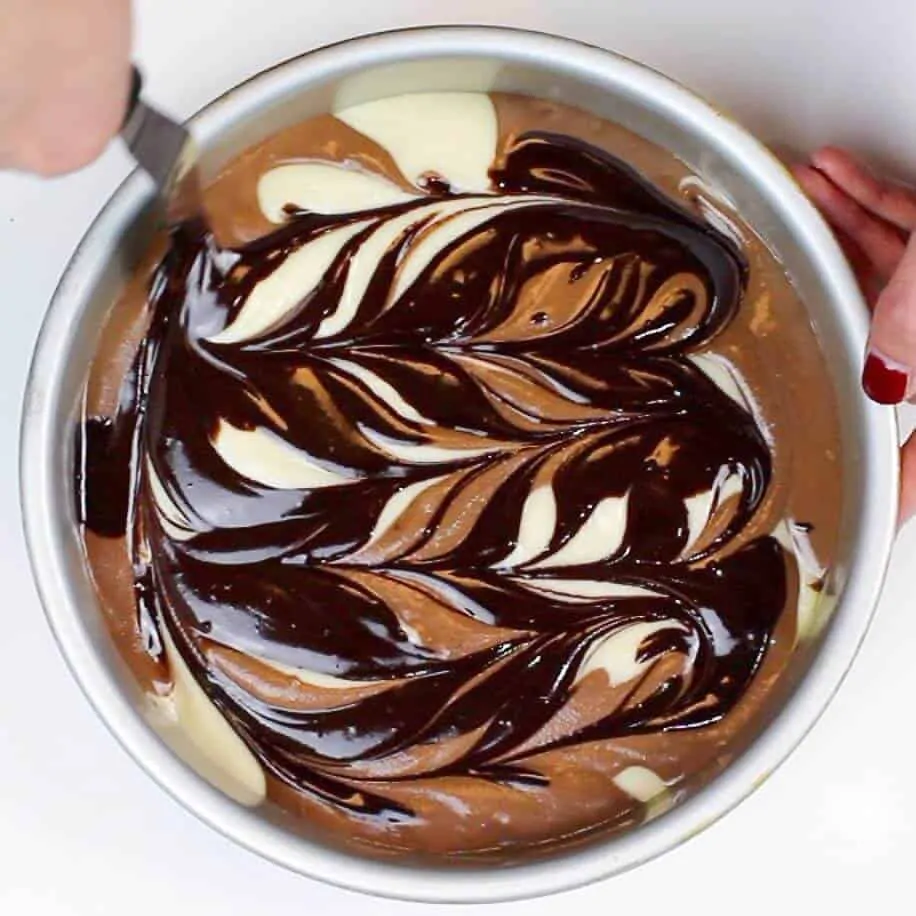 swirling the batter to make my marble cake layers