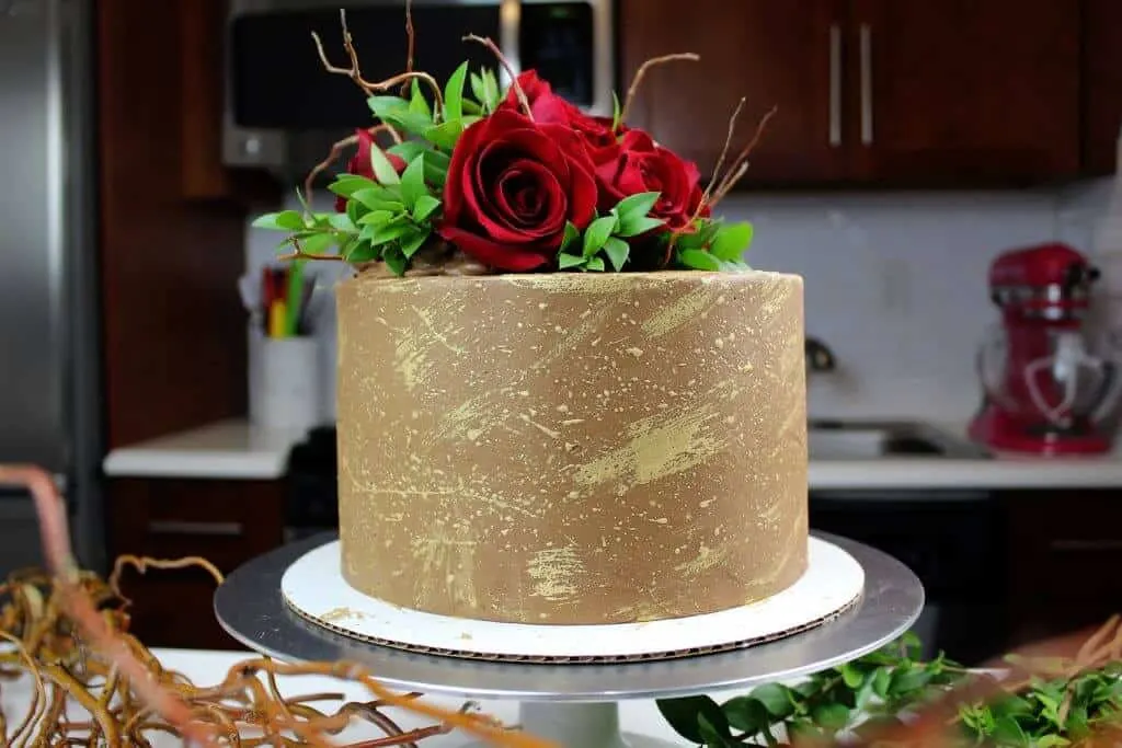 chocolate engagement cake decorated with edible gold and fresh roses photo