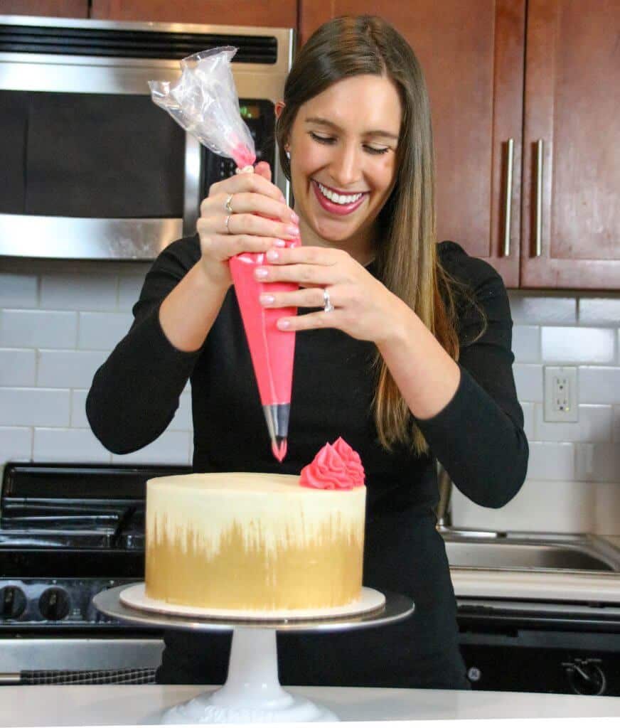 image of chelsey white piping frosting onto a cake