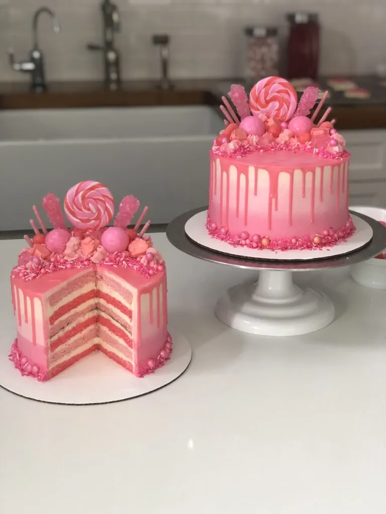 image of a cute pink drip cake that's been decorated with matching pink candy