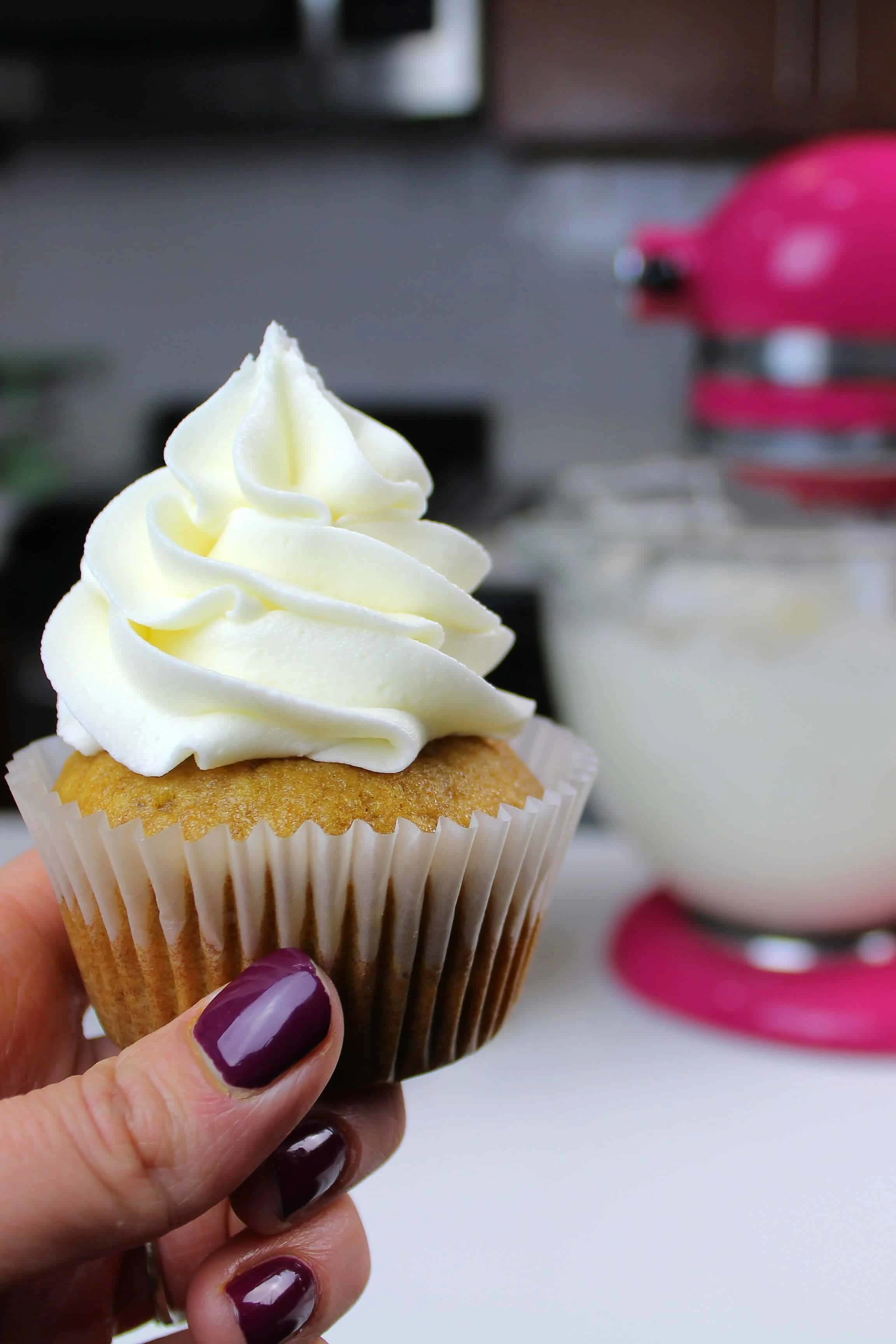 cream cheese buttercream frosted onto a pumpkin cupcake