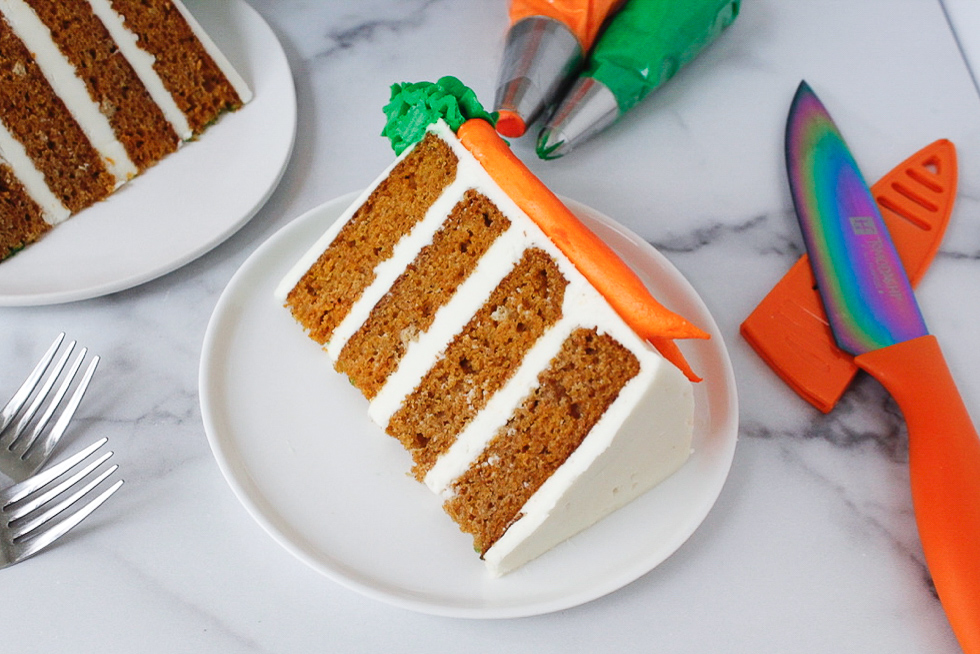 image of slice of moist carrot cake, frosted with cream cheese frosting