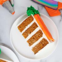 image of slice of spicy carrot cake, frosted with cream cheese frosting