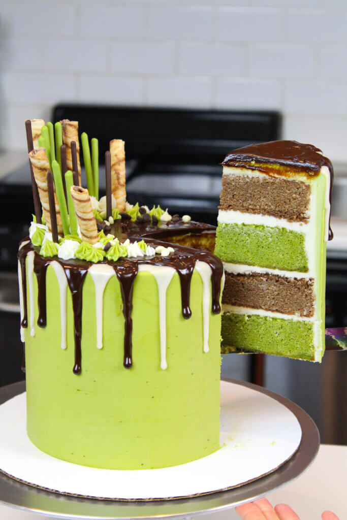pulling slice out of chocolate matcha drip cake