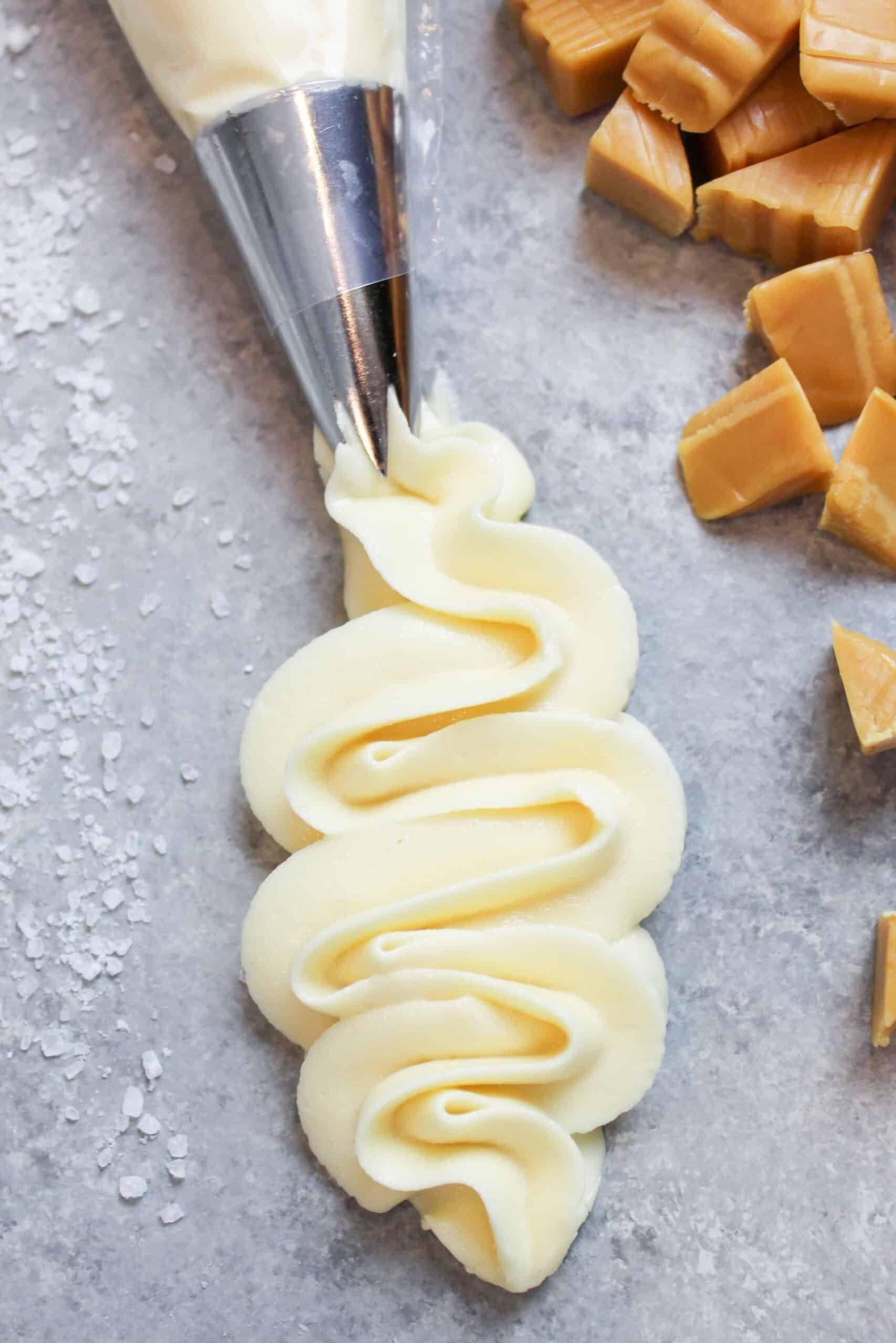 image of salted caramel frosting that's being piped with a wilton 1m frosting tip