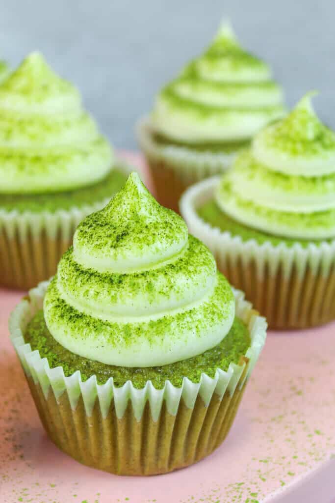Matcha cupcakes decorated with vanilla buttercream, dusted with matcha powder