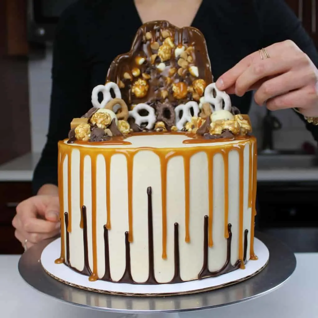 image of cake with double drip, made with chocolate ganache drips and caramel drips