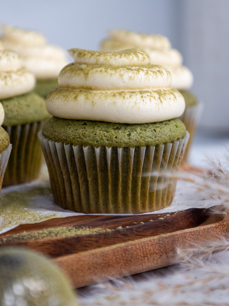 image of matcha cupcakes that have been frosted with vanilla buttercream