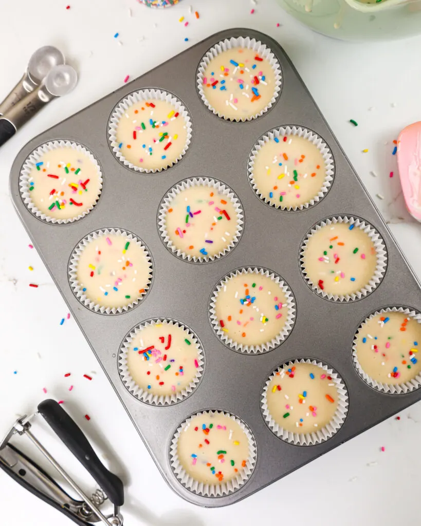 image of funfetti cupcake batter that's been scooped into liners and is ready to be baked