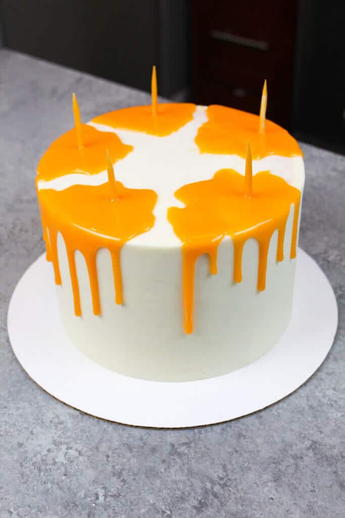 image of cake with orange mirror glaze drips