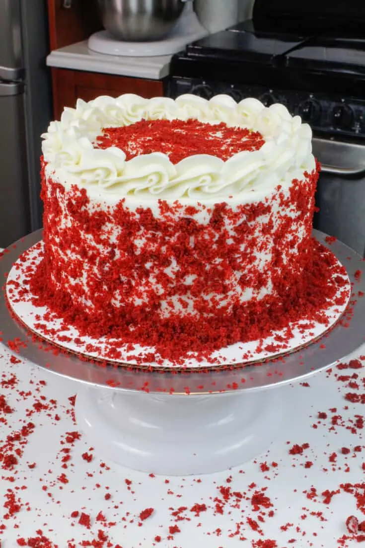 image of moist red velvet cake, decorated with reserved red velvet crumbs