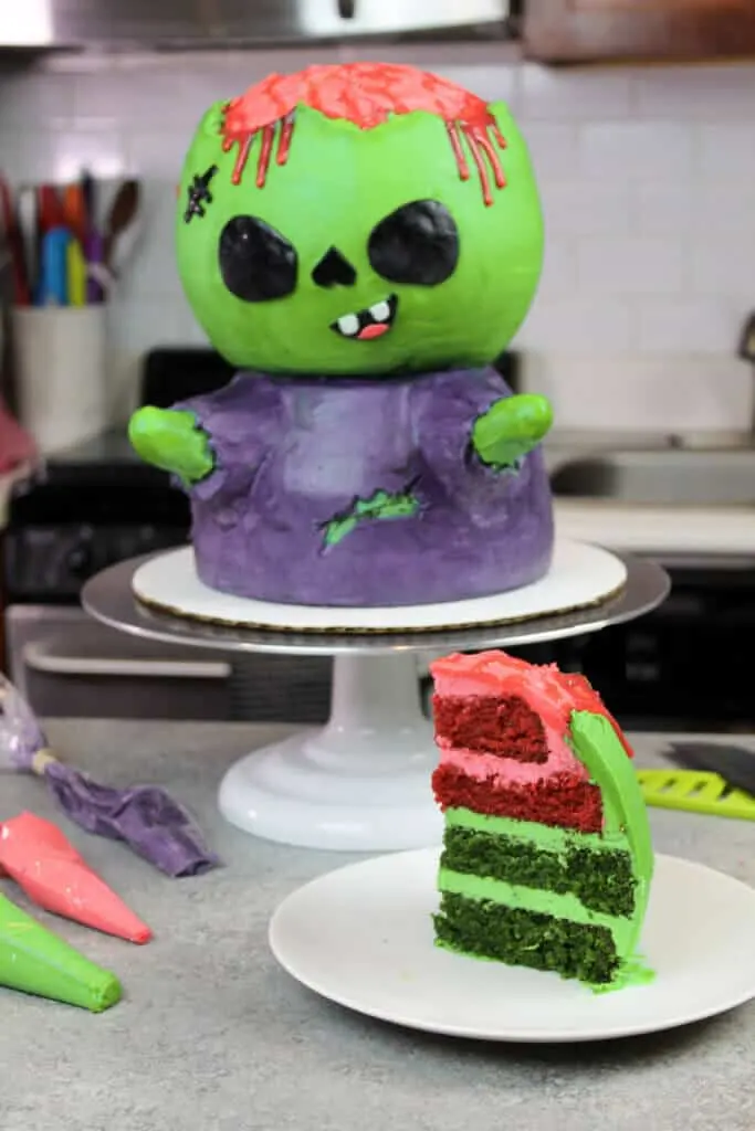 image of zombie cake with cake slice of green and red velvet cake layers